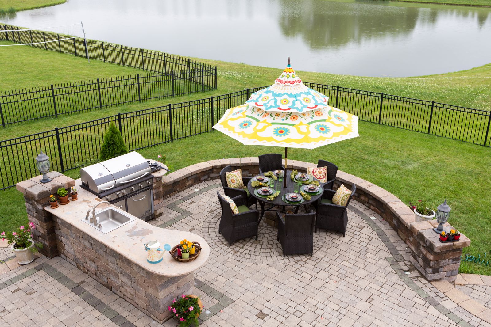 Paver patio with a built-in grill island and dining area